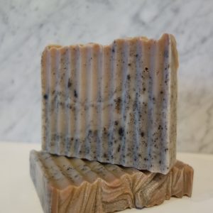 2 Dirty Chai soap bars, 1 laying flat with the other standing on top of it.